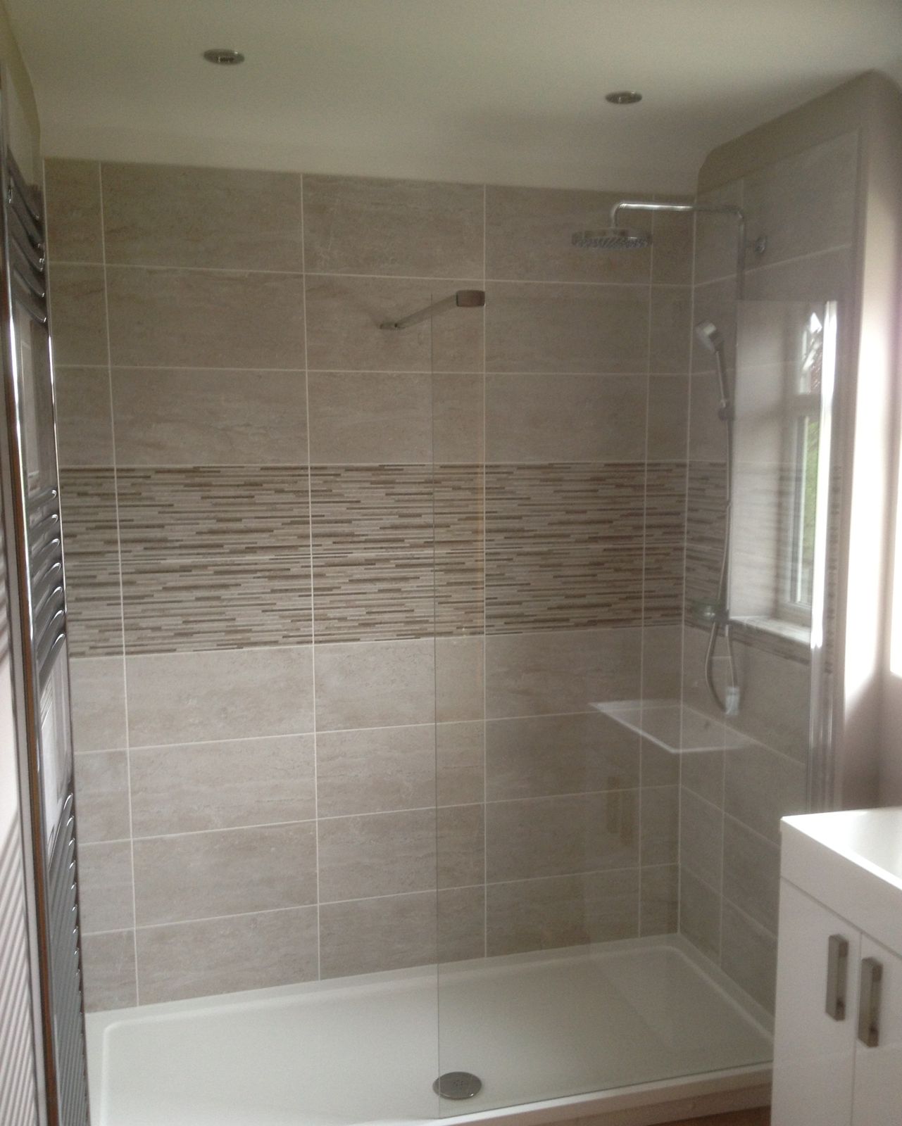 Walk-in shower with feature tiling and wall-hung vanity