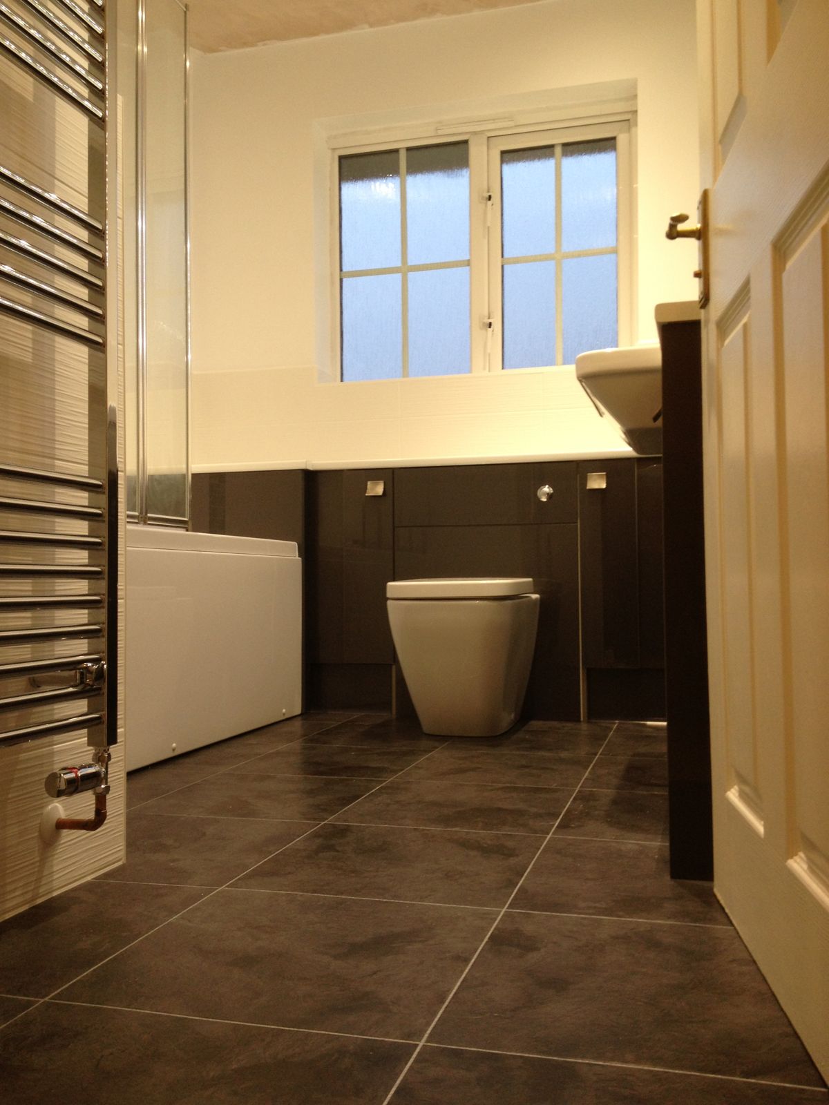 Fully tiled family bathroom with towel radiator