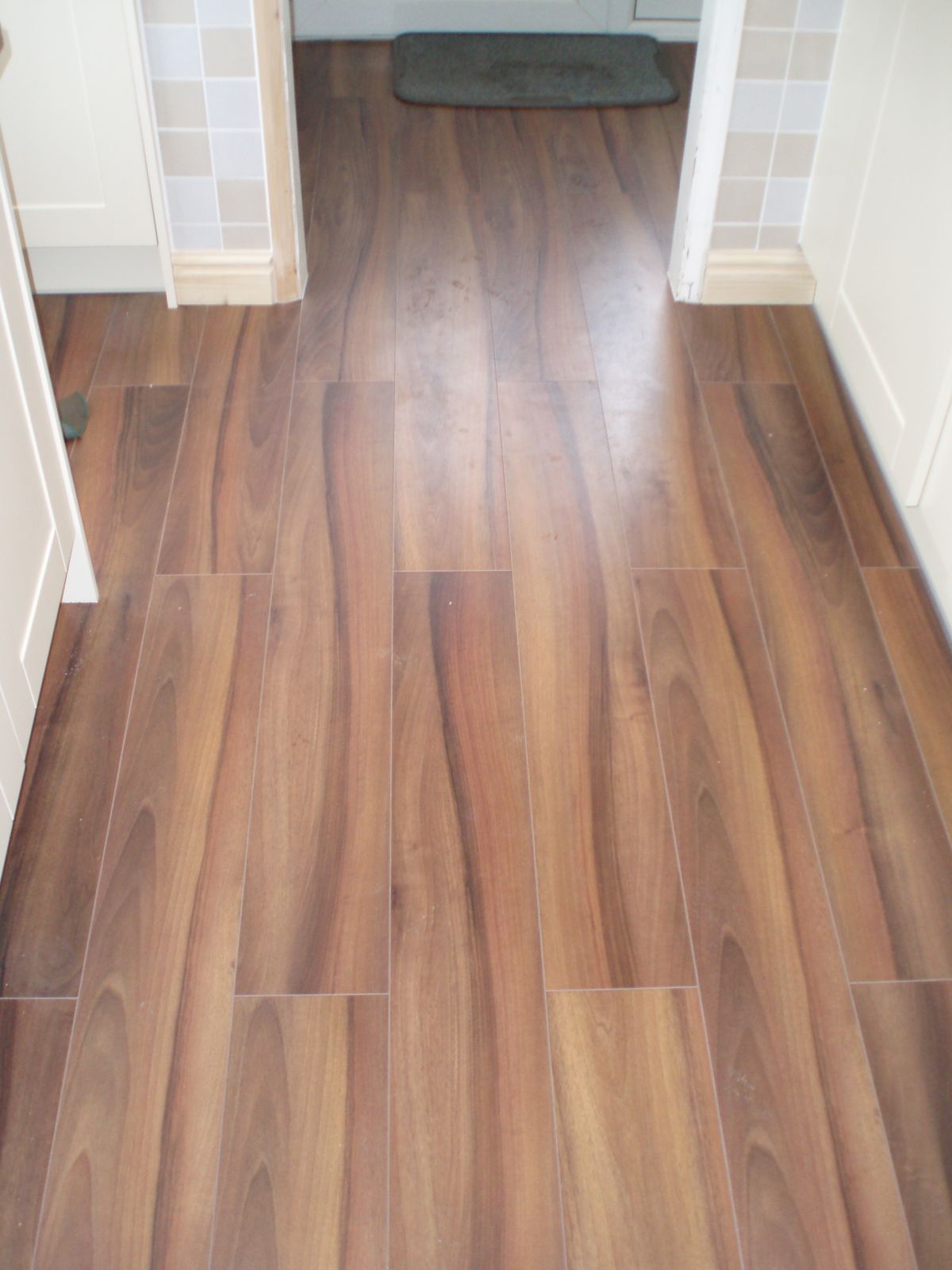 Laminate flooring flowing through hall and living space