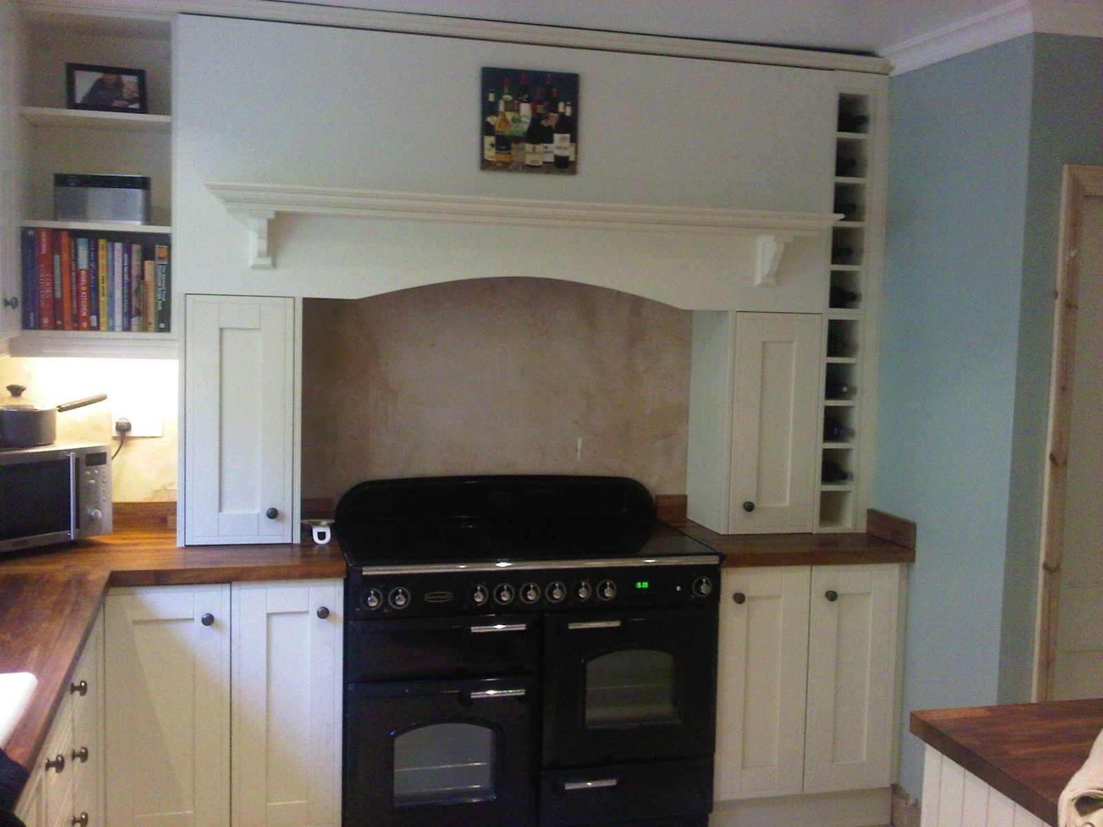 Bespoke chimney surround and cabinetry around a range cooker, Stroud