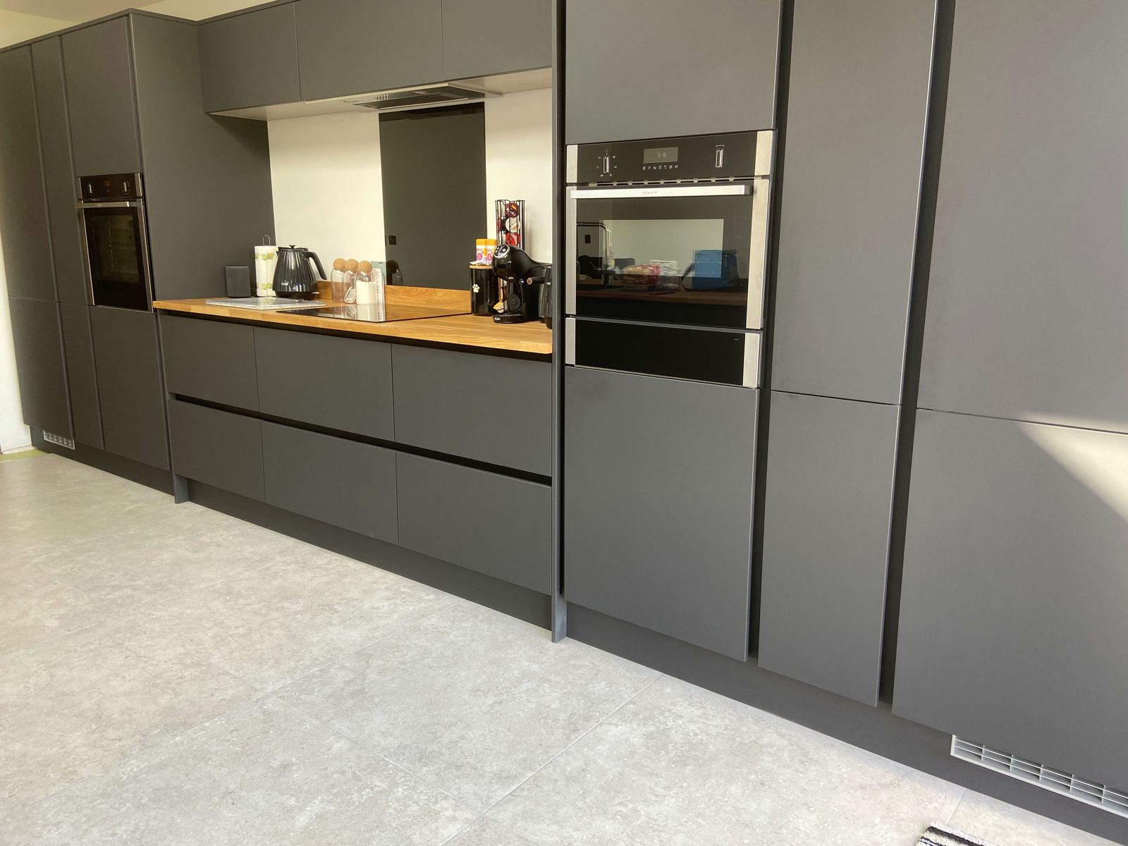 Graphite handleless kitchen with oak worktops