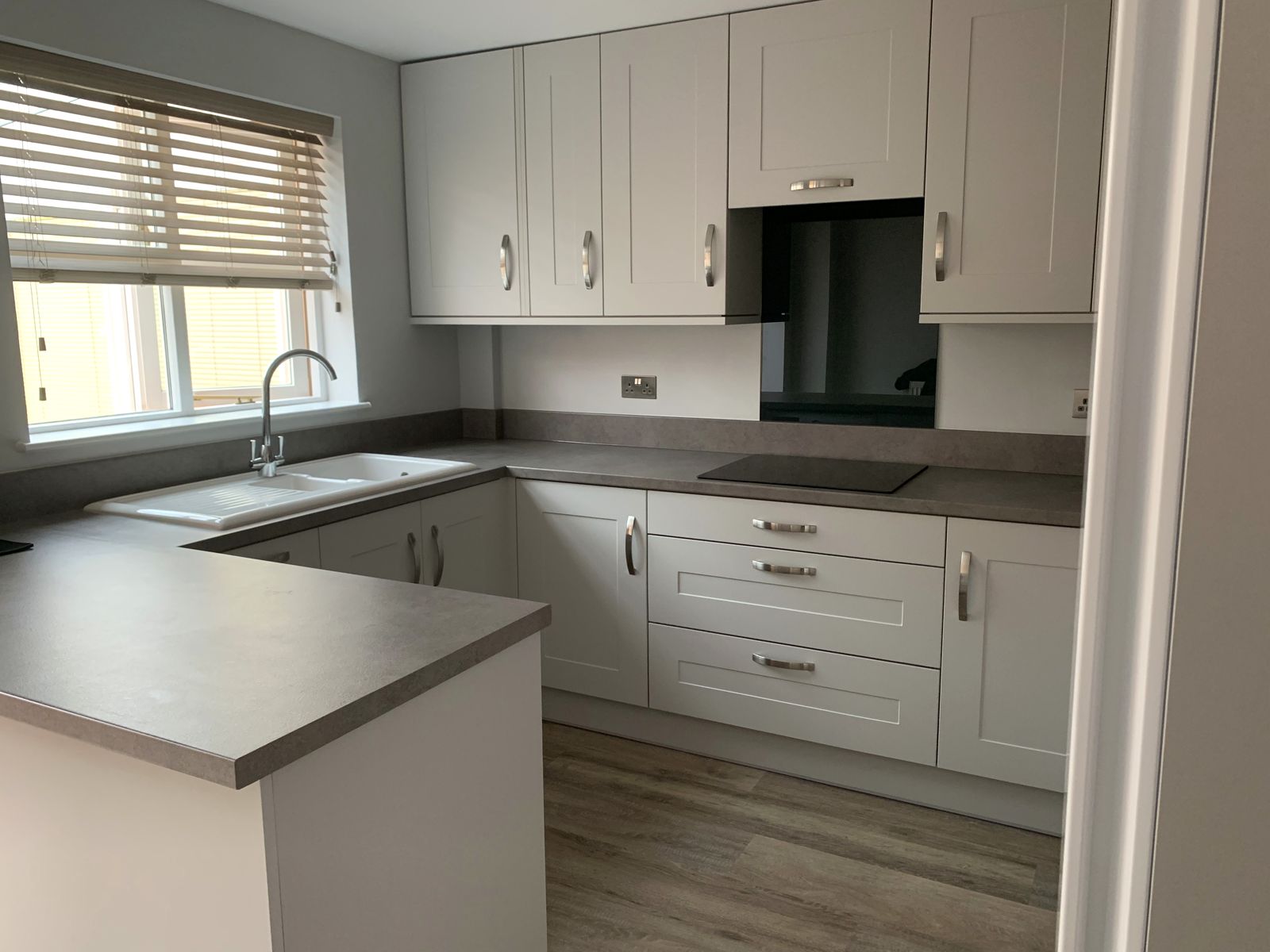 Grey shaker kitchen with induction hob