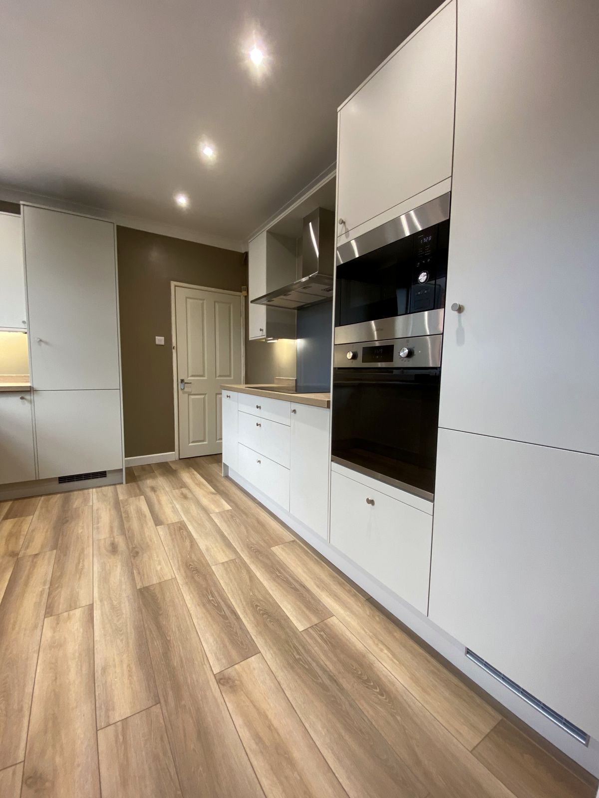 White handleless galley kitchen